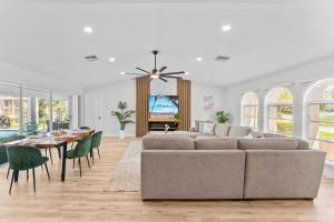 a living room with a couch and a table at Waterfront Pool Game Room Gulf Access in Cape Coral