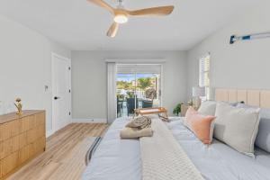 a bedroom with a bed with a ceiling fan at Waterfront Pool Game Room Gulf Access in Cape Coral +37 photos