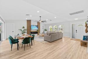a living room with a table and a couch at Waterfront Pool Game Room Gulf Access in Cape Coral