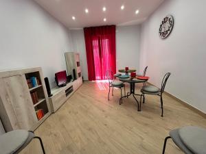 a living room with a table and chairs and a television at B&B Gino&Giulia in Aprilia