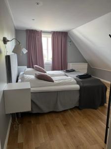 a bedroom with a bed in a attic at Lindens Bed&Breakfast in Mellerud