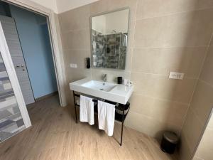a bathroom with a sink and a mirror at B&B Gino&Giulia in Aprilia +34 photos
