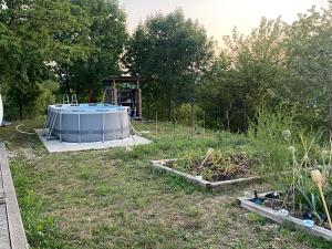a garden with a hot tub in a field at Romantisches Tiny House mit Pool and Air Condition in Tržec