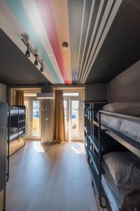 a room with bunk beds and a rainbow ceiling at CATS Porto Hostel in Porto +39 photos