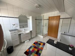 a bathroom with a tub and a sink and a shower at Haus Milan in Holzminden +10 photos