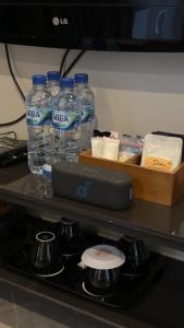 a bottle of water sitting on top of a stove at Edy's Farm Cottage in Jabon