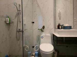 a bathroom with a shower and a toilet and a sink at Edy's Farm Cottage in Jabon +93 photos