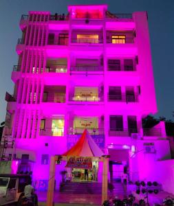 a pink building with a tent in front of it at Hotel Shaktideep in Pushkar