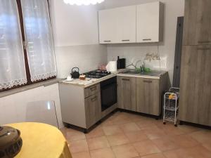 a kitchen with white cabinets and a stove top oven at Casa Anima Allegra in Triban