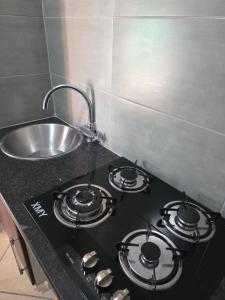 a kitchen counter with a stove and a sink at The Good Samaritan 4 in eMalahleni