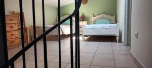a bedroom with a bed and a dresser in it at Le chèvrefeuille in Sahune