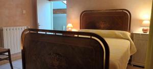 a bedroom with a large bed with a wooden headboard at Le chèvrefeuille in Sahune +9 photos