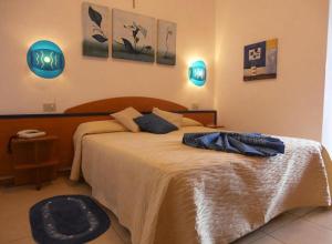 a bedroom with a large bed with blue lights at Hotel Toscana in Marotta