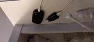 a hairbrush and a hair dryer on the wall of a bathroom at Appartamento Vacanze Malù in Moneglia
