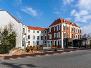 a group of buildings on the side of a street at Mercure Saint Omer Centre Gare in Saint-Omer