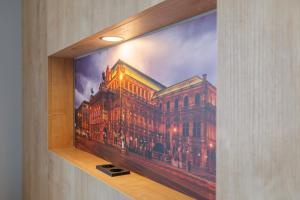 a picture of a building on a wall at Luci House Boutique Hostel - Vienna 15th district in Vienna
