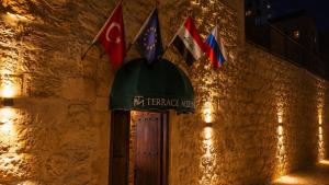 a entrance to a building with flags on it at Terrace Merdin Konagı in Mardin