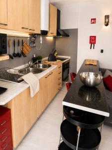 a kitchen with a sink and a counter top at Estudio Boho Mar in Praia da Rocha