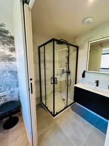 a bathroom with a glass shower and a sink at 6 Suites Signature in Saint-Jacques-de-la-Lande +127 photos