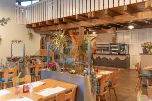 a restaurant with wooden tables and wooden chairs at Hotel Thüringenschanze in Oberhof