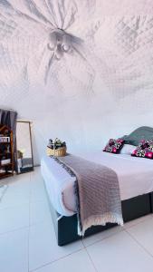 a bedroom with a bed with a ceiling fan at ออโต้แคมป์ in Ban Huai Khu
