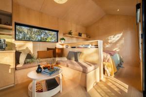 a small living room with a couch and a table at HeartStone Hill - Tiny House in Castlemaine
