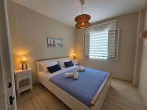 a bedroom with a bed with a teddy bear on it at Greek Memories in Artemida +55 photos