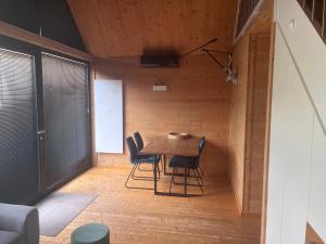 a small dining room with a table and chairs at Ferienhaus an der Wasserkuppe in Poppenhausen +7 photos
