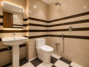 a bathroom with a toilet and a sink at Radhe Shyam Resort Vrindavan By HRG Hotel Near Prem Mandir in Vrindāvan