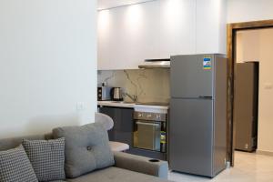 a kitchen with a refrigerator and a couch in a room at Bohemia palace in Hurghada