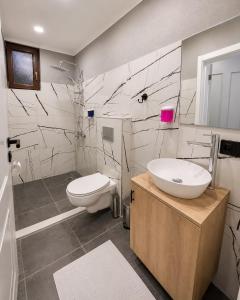 a bathroom with a sink and a toilet at Blue Sea Hotel in Tuzla +26 photos