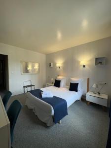 a hotel room with a large bed in a room at Hôtel La Redoute in Les Rousses