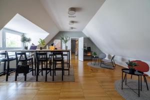 a dining room and living room with a table and chairs at Luci House Boutique Hostel - Vienna 15th district in Vienna