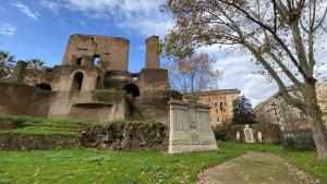 an old building with a grave in the grass at Rome Innitaly Affittacamere o GuestHouse in Rome