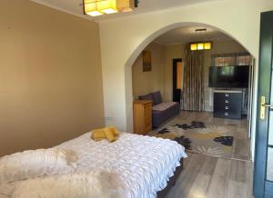 a bedroom with a bed and a living room at Casa Petrişor in Corbi