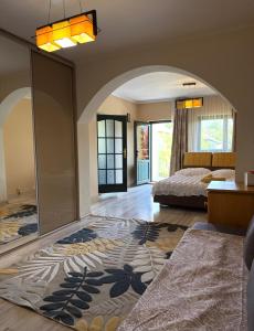 a bedroom with a bed and a large rug at Casa Petrişor in Corbi