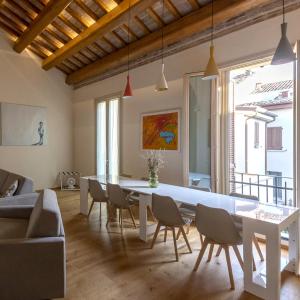 a dining room with a white table and chairs at Antica Corte Lugo in Lugo