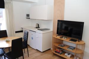a living room with a small table and a television at Neckelmanns BnB, Room 36 