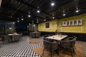 a restaurant with tables and chairs in a room at Wanderlust A Boutique Homestay in Udaipur