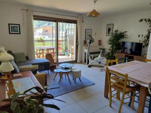 a living room with a couch and a table at Modern appartmenr in Bozel
