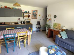 a kitchen and living room with a table and a couch at Modern appartmenr in Bozel +20 photos