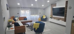 a living room with a couch and a tv at Villa View in Neum