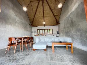 a living room with a couch and a table at The Villa Indah Areguling in Kuta Lombok