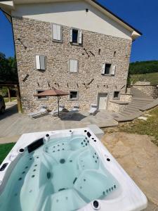 a jacuzzi tub in front of a building at Vessa 3 in Selvapiana +10 photos