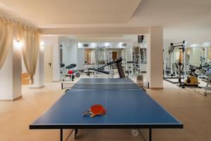 a gym with a ping pong table and exercise equipment at Royal Luxury Villa by AKTIS VILLAS in Kriopigi