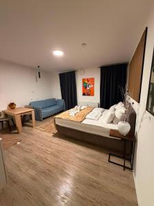 a bedroom with a large bed and a couch at Eibisch Apartments in Passau