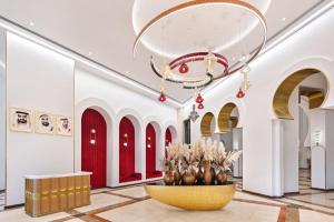a lobby with a large fountain in the middle of a building at Oaks Ibn Battuta Gate Dubai in Dubai