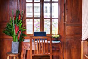 a dining room with a table and chairs and a window at The Cottage By Selasih in Seminyak