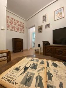 a living room with a table with a book on it at Domaine Lainault - Logement des Vignerons in Lhomme