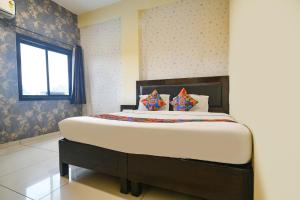 a bedroom with a large bed in a room at FabHotel Shree I in Indore